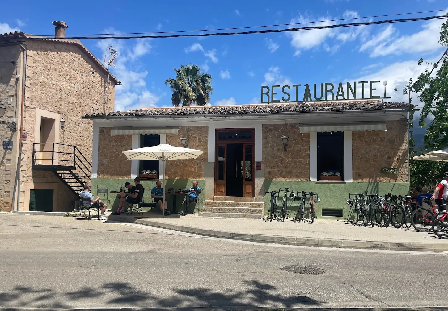 Cyclist cafe stop on the Mallorca grand traverse — refuelling on the Andratx to Pollença route