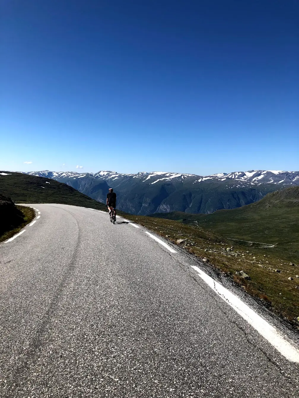 Aurlandsfjellet cycling Norway — descent from the Snow Road summit toward Aurland and the Sognefjord