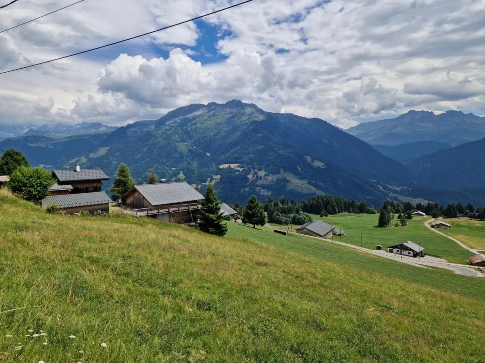Beaufortain balcony: chalets, high meadow and Alpine ridges beyond