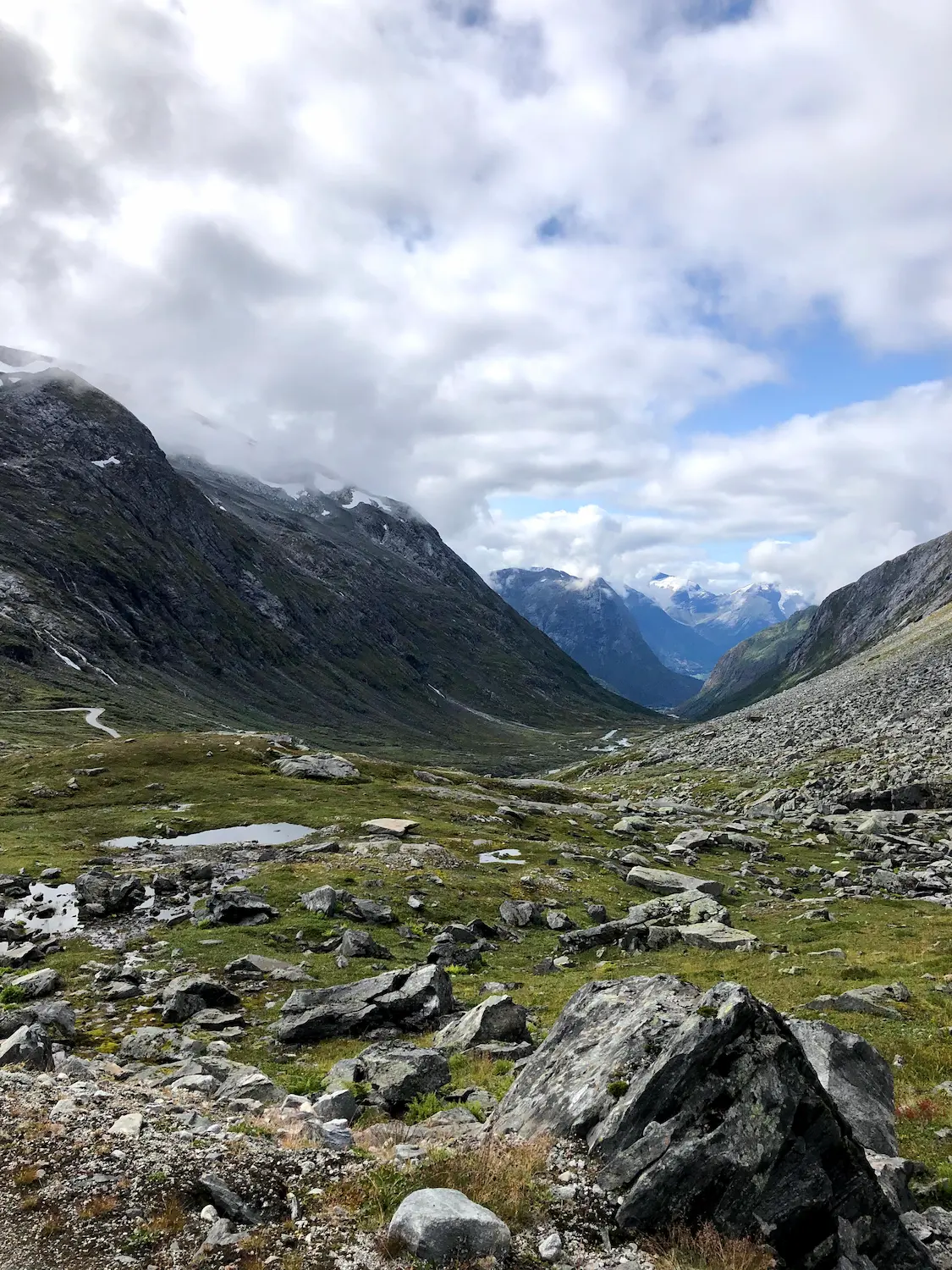Cycling the historic Strynefjell road, Norway — rough asphalt giving way to compacted gravel near the summit