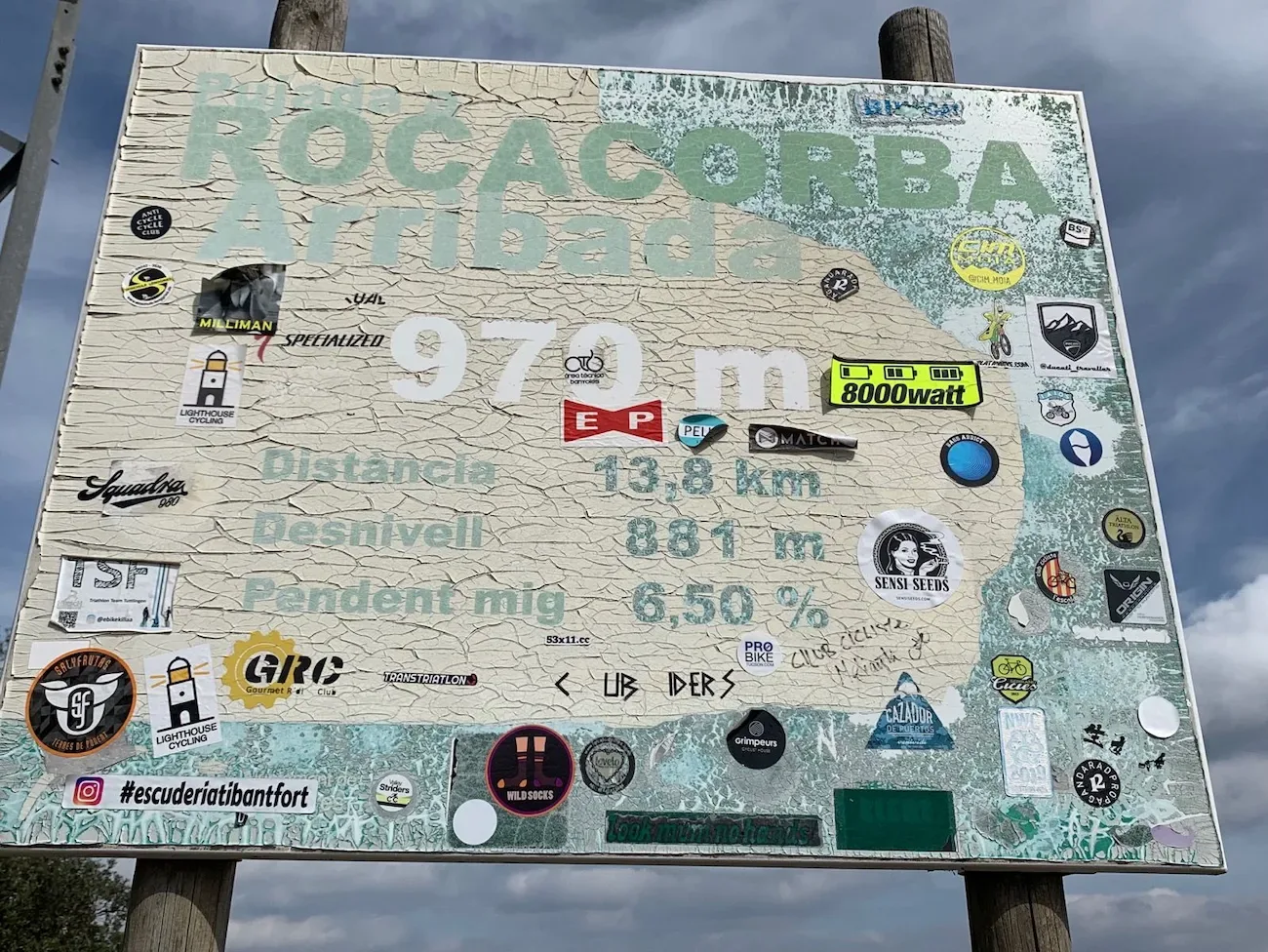 Sticker-plastered Rocacorba Arribada board at the summit