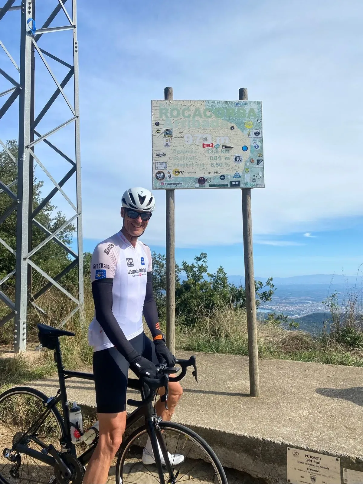 Bike propped at the summit sign after the effort up