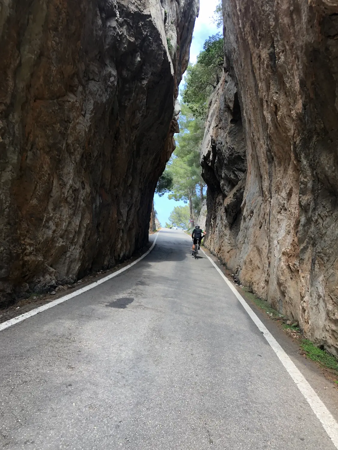 Cycling between the two rock walls on Sa Calobra climb, the iconic narrow section on Mallorca's queen stage.
