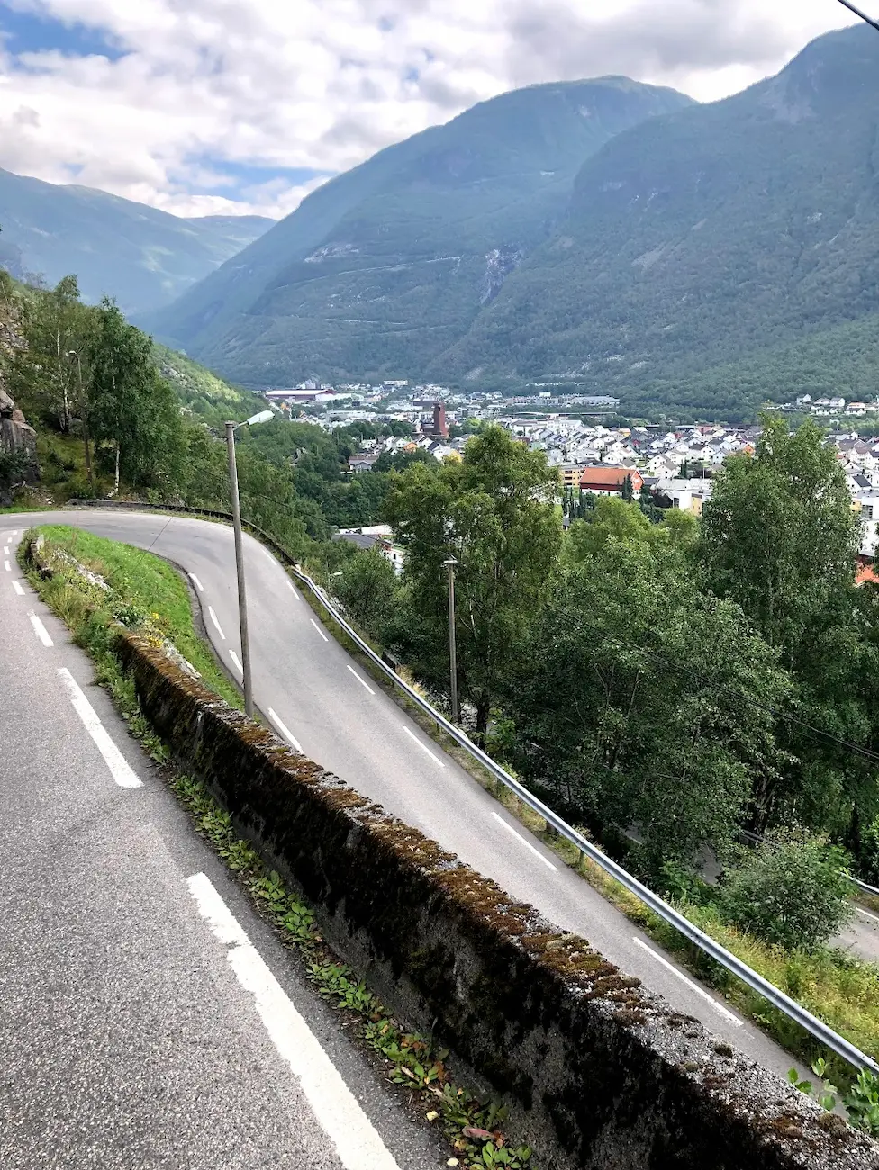 Tindevegen switchbacks from Øvre Årdal — HC-rated toll road through Jotunheimen with views of Hurrungane peaks
