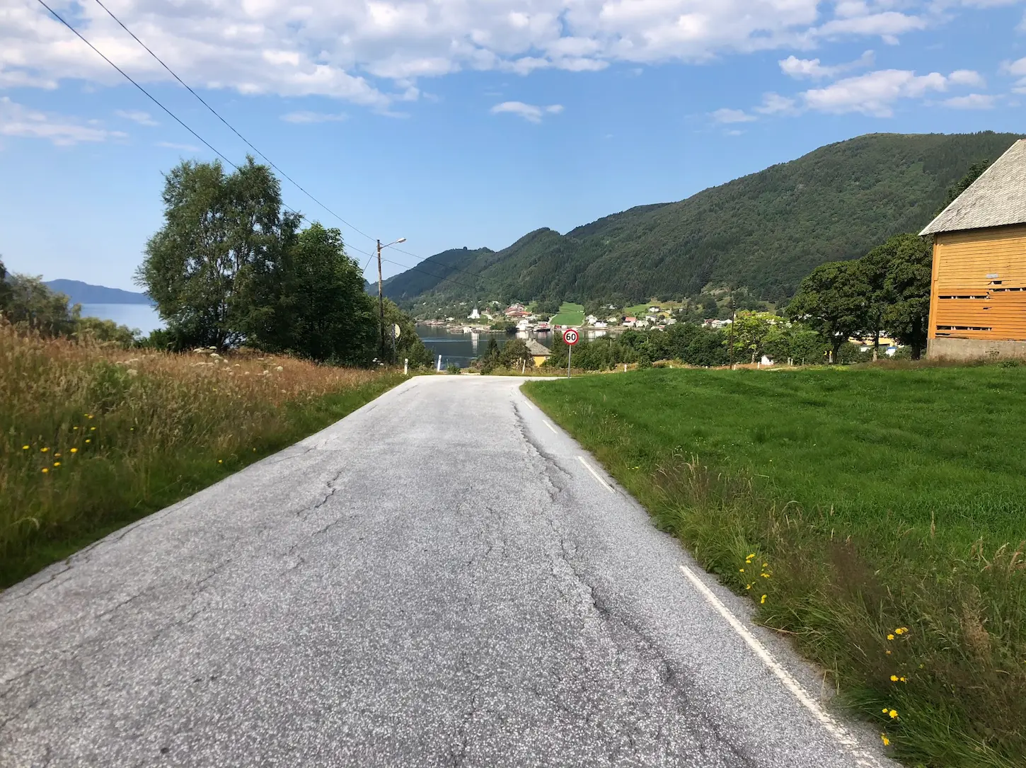 Cycling to Hyllestad — the iconic Lihesten mountain dominates the skyline above the village