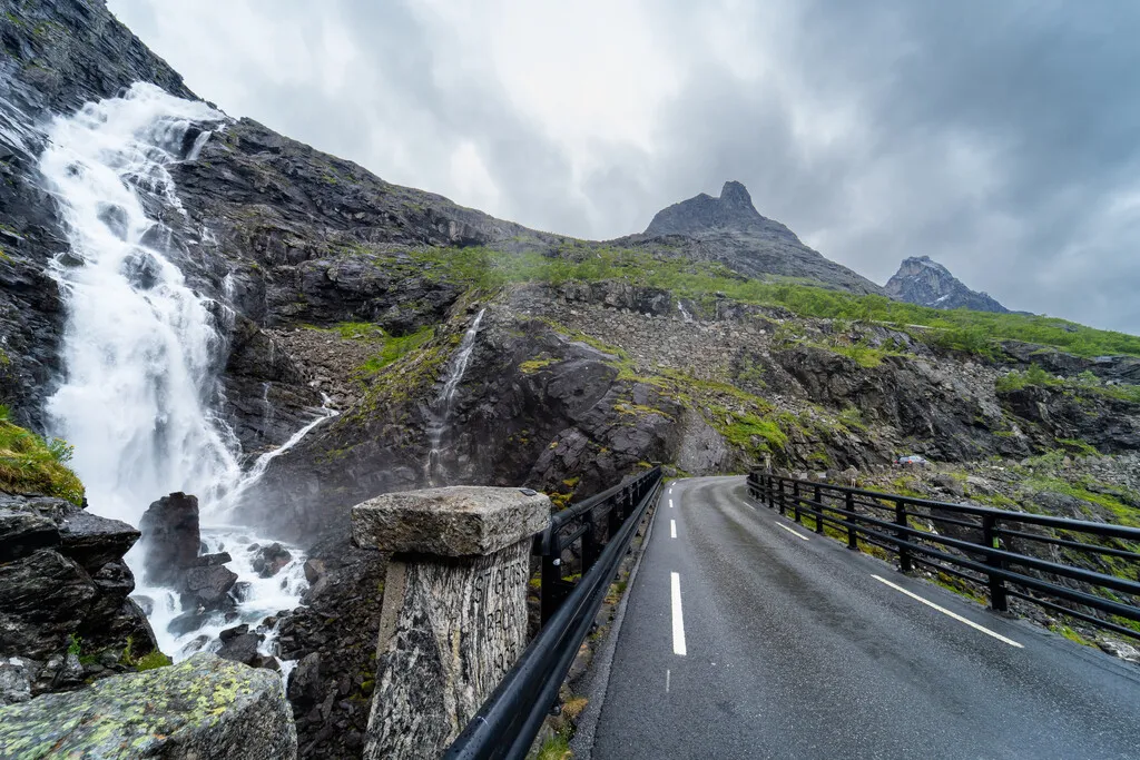 Stigfossbrua crosses the Stigfossen waterfall on the way up Trollstigen, spray reaching the tarmac.